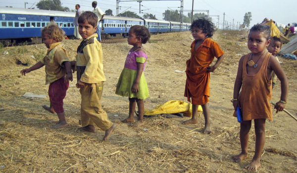 Children playing next to railroad.