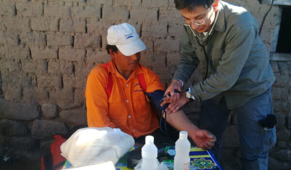 Víctor-Orellana-at-work-as-a-health-care-worker-in-a-small-village-in-Argentina.Here-with-a-patient