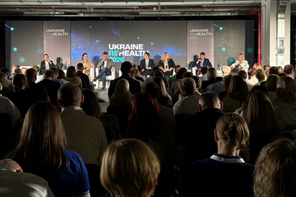 Audience at the ReHealth conference in Ukraine looking at a panel of speakers on the stage. 