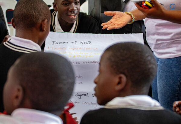 Group of boys at Munali Secondary School in Lusaka, Zambia discussing drivers of AMR. Photo: ReAct Africa.
